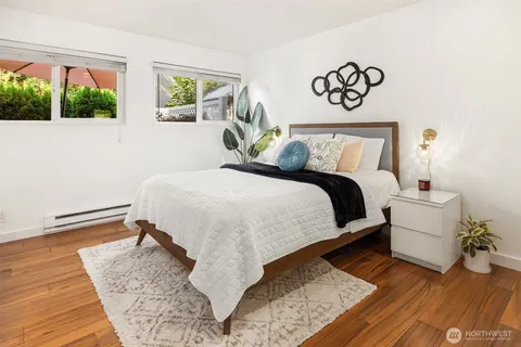 a bedroom with a bed and wooden floor