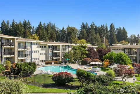 a view of a house with backyard garden and trees