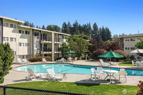 a swimming pool with outdoor seating and yard
