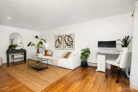 a living room with furniture and a wooden floor