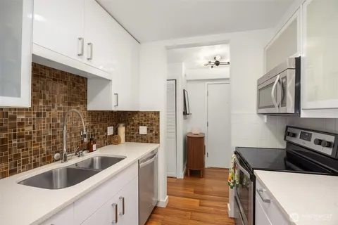 a kitchen that has a sink and a stove