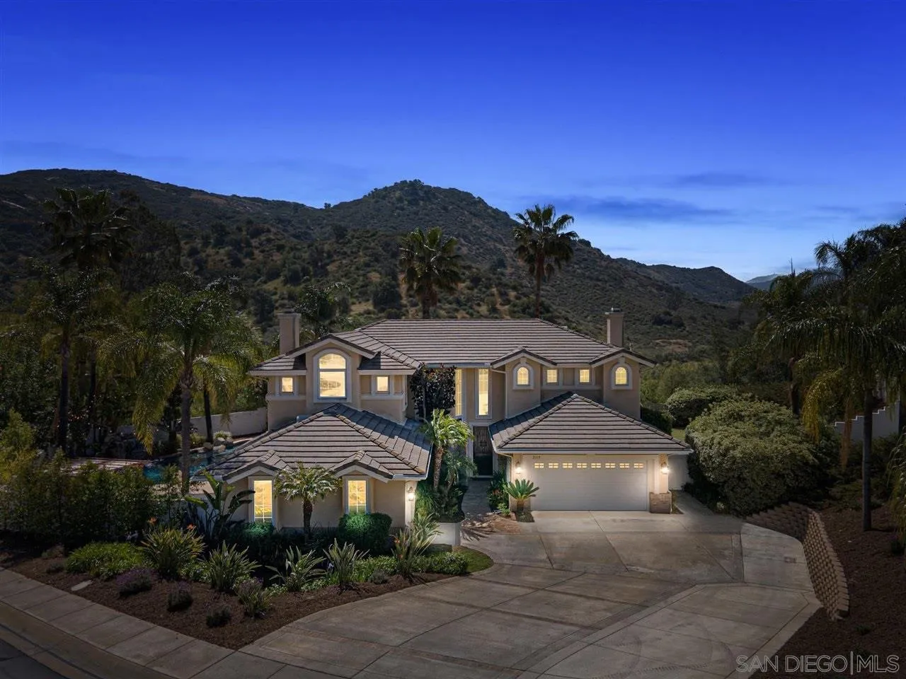 2319 Ranchview Place Escondido, CA 92027 - Photo 3 of 47 a front view of a house with a yard and mountain in the background