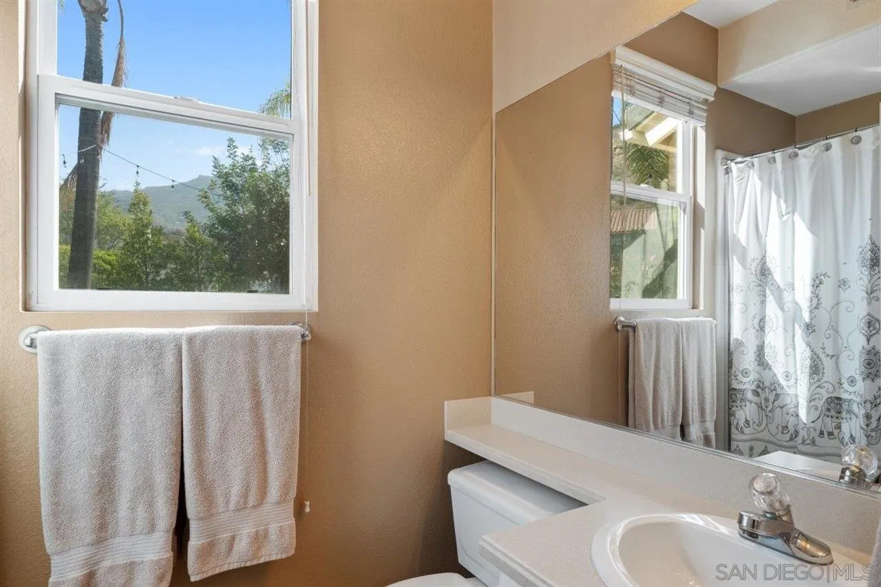 2319 Ranchview Place Escondido, CA 92027 - Photo 36 of 47 a bathroom with a sink and a mirror