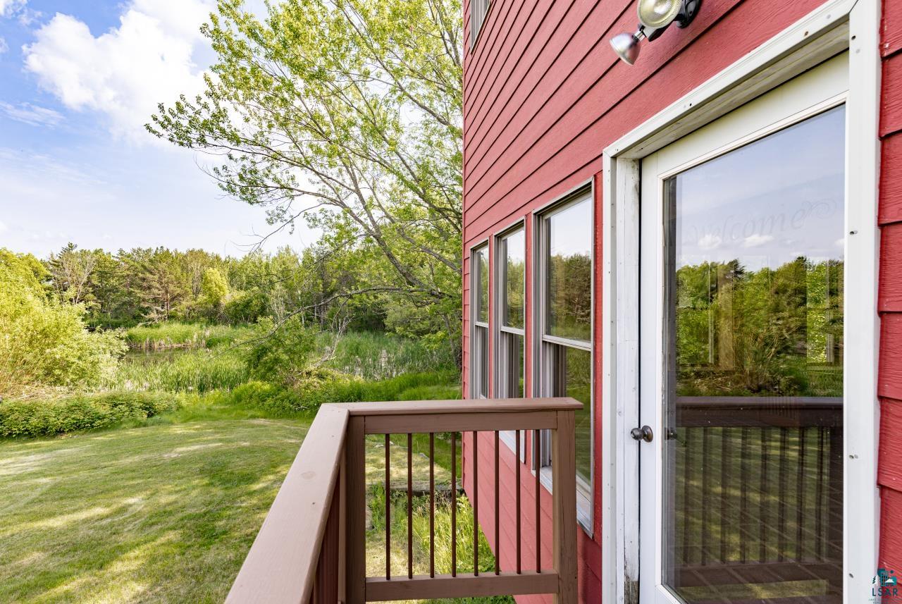 4800 Tower Road Moose Lake, MN 55767 - Photo 44 of 83 Exterior deck featuring wood railing, red siding, and multiple windows
