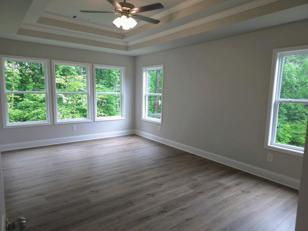 4240 Cavalier Way Duluth, GA 30097 - Photo 26 of 46 a view of an empty room with wooden floor and a window