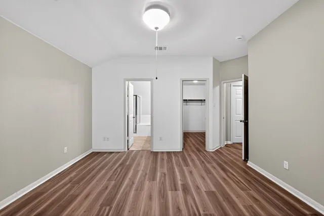 a view of a room with wooden floor and a sink