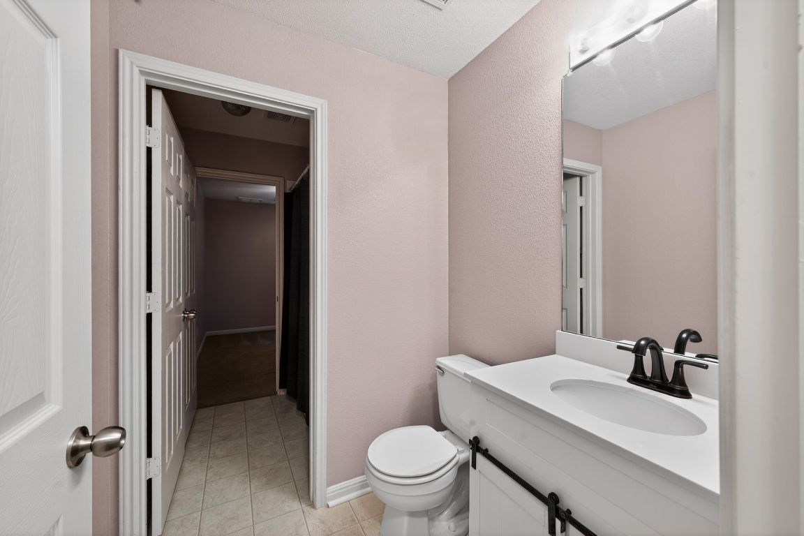 13237 Pine Needle Street Manor, TX 78653 - Photo 12 of 16 Bathroom with vanity, a shower with curtain, and light tile patterned floors
