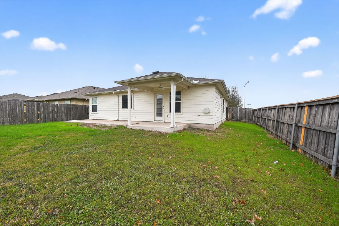 13237 Pine Needle Street Manor, TX 78653 - Photo 16 of 16 Back of property featuring a patio, a fenced backyard, and ceiling fan