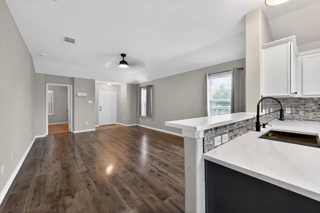 a kitchen with a sink and a stove top oven