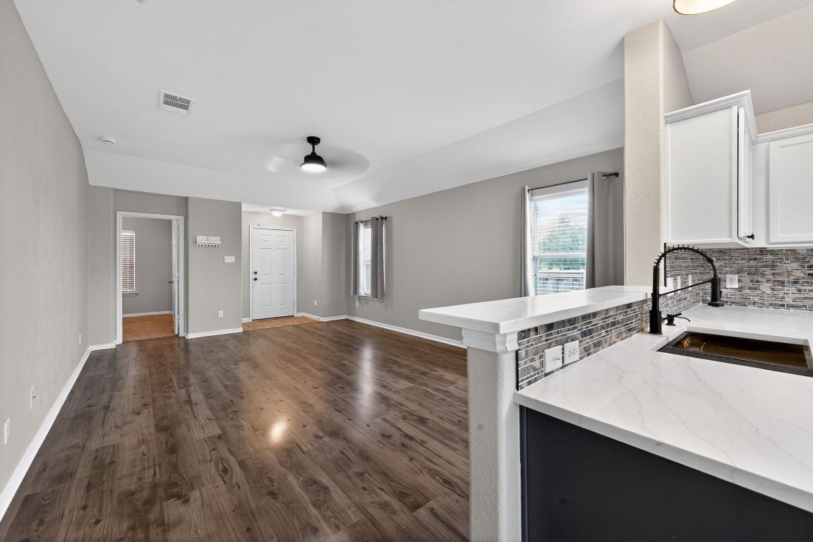 13237 Pine Needle Street Manor, TX 78653 - Photo 3 of 16 living room with a sink and dark wood-type flooring