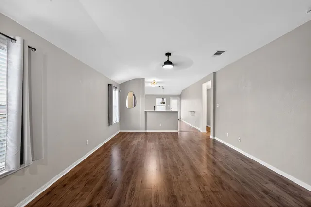 a view of a kitchen with wooden floor and a sink