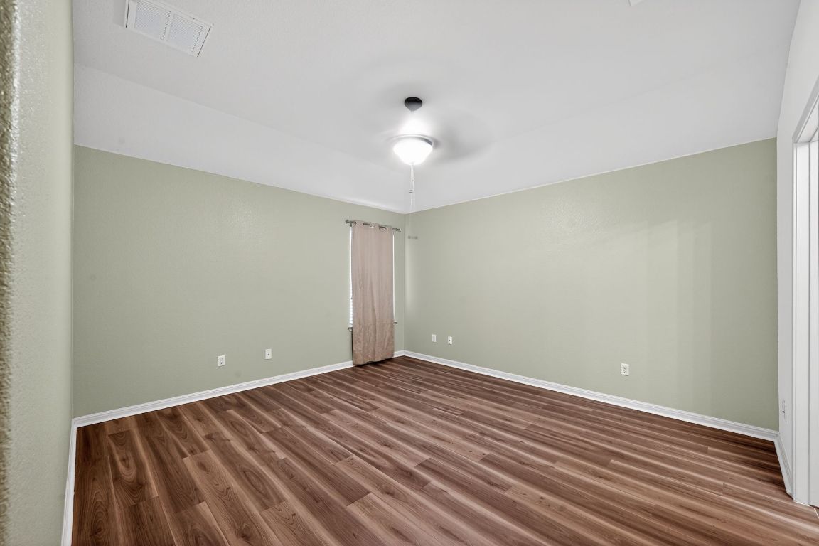 13237 Pine Needle Street Manor, TX 78653 - Photo 9 of 16 bedroom featuring dark wood finished floors and a ceiling fan