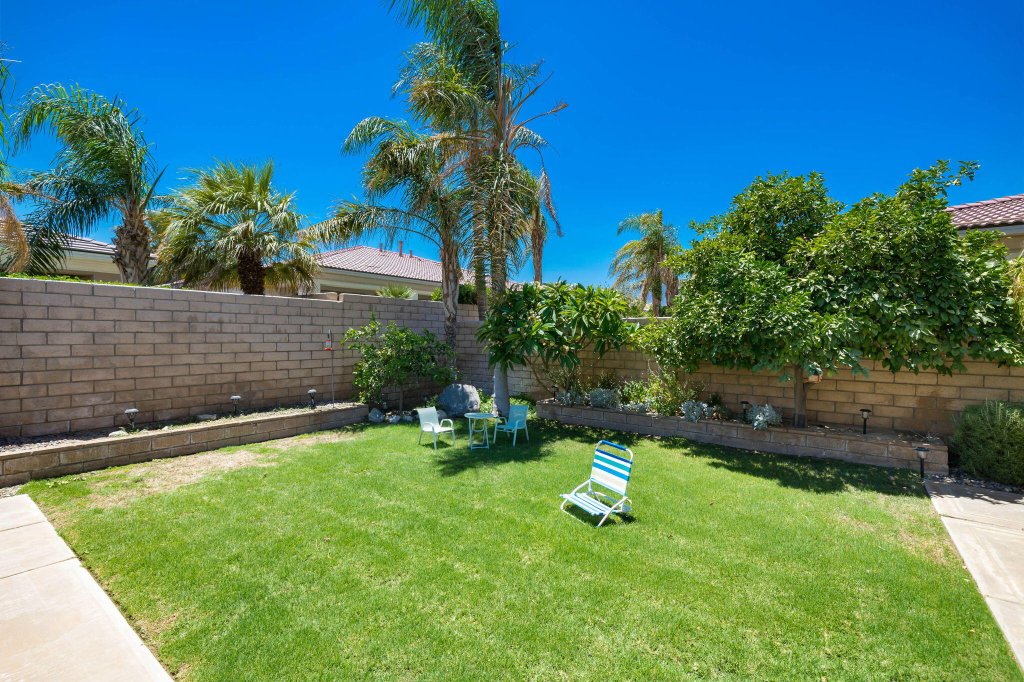68 Via Del Pienza Rancho Mirage, CA 92270 - Photo 16 of 38 a view of a backyard with a sitting area