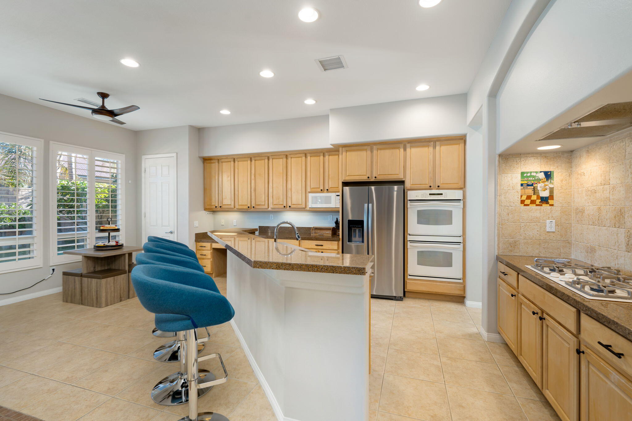 68 Via Del Pienza Rancho Mirage, CA 92270 - Photo 23 of 38 a kitchen with stainless steel appliances kitchen island granite countertop a refrigerator and a stove top oven
