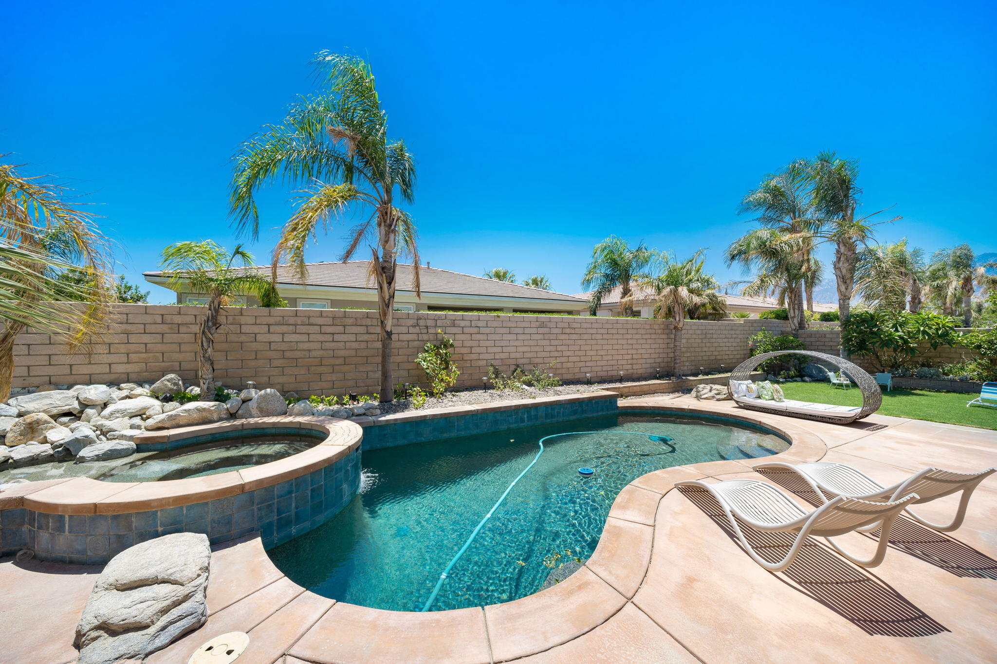 68 Via Del Pienza Rancho Mirage, CA 92270 - Photo 7 of 38 a view of swimming pool with a garden and patio
