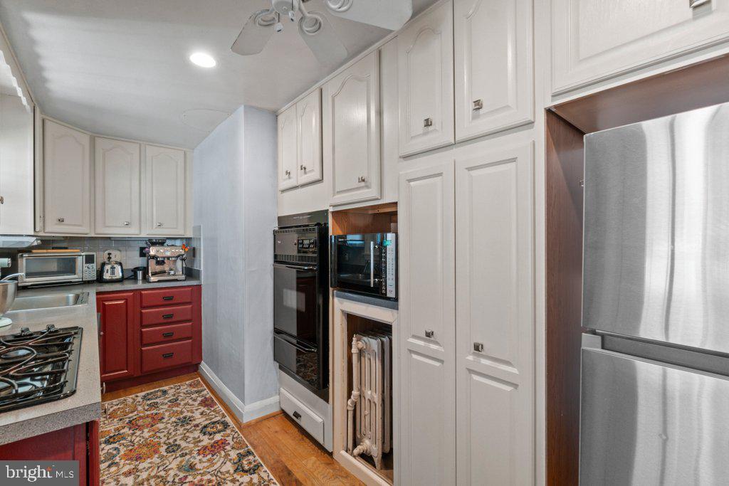 5937 Falls Road Baltimore, MD 21209 - Photo 15 of 42 a kitchen with stainless steel appliances granite countertop a refrigerator and a stove top oven