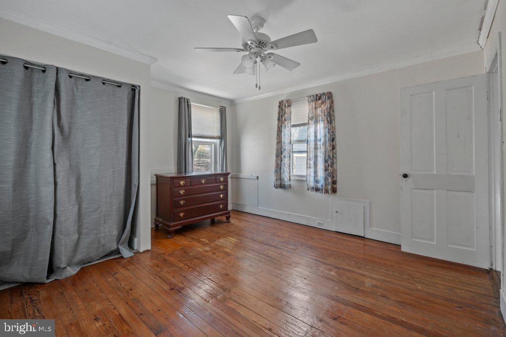 5937 Falls Road Baltimore, MD 21209 - Photo 20 of 42 an empty room with wooden floor closet and windows