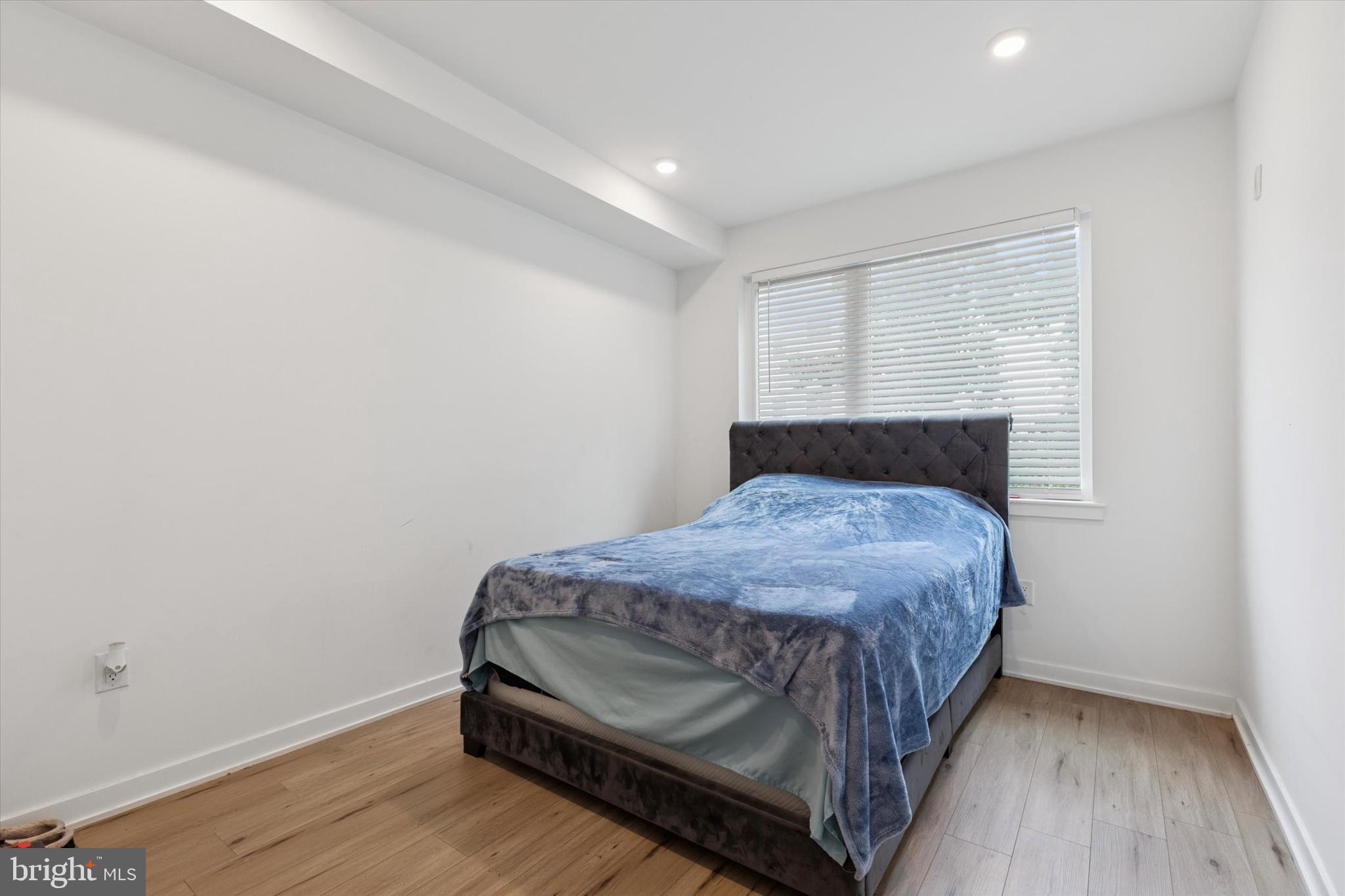 22 East Rittenhouse Street Philadelphia, PA 19144 - Photo 19 of 34 a bedroom with a bed and wooden floor