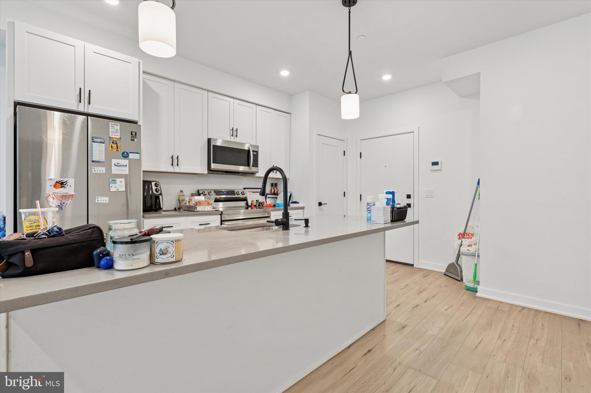 22 East Rittenhouse Street Philadelphia, PA 19144 - Photo 24 of 34 a kitchen with kitchen island a stove a sink a refrigerator and cabinets