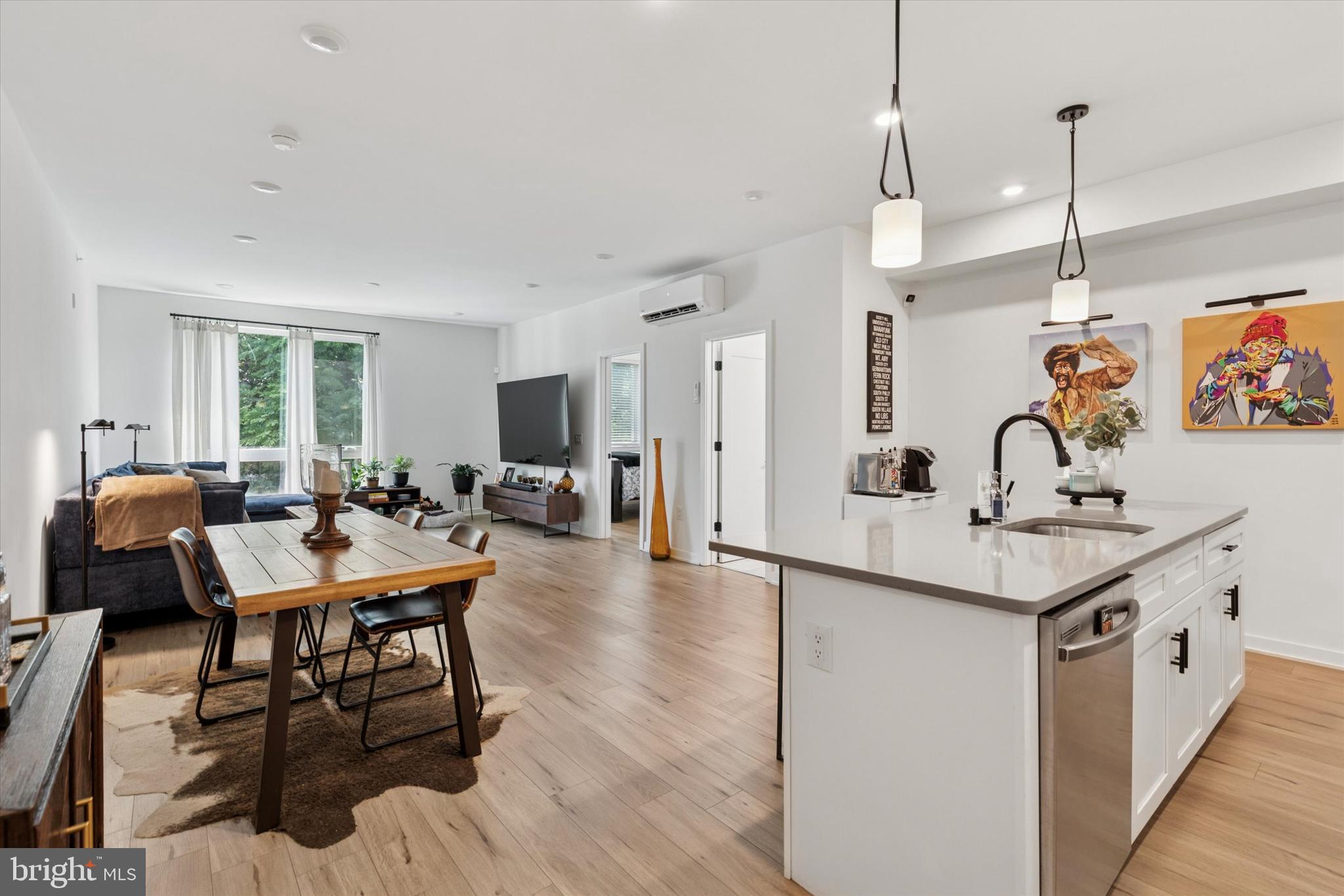 22 East Rittenhouse Street Philadelphia, PA 19144 - Photo 5 of 34 a kitchen with stainless steel appliances kitchen island granite countertop a table chairs in it and wooden floors