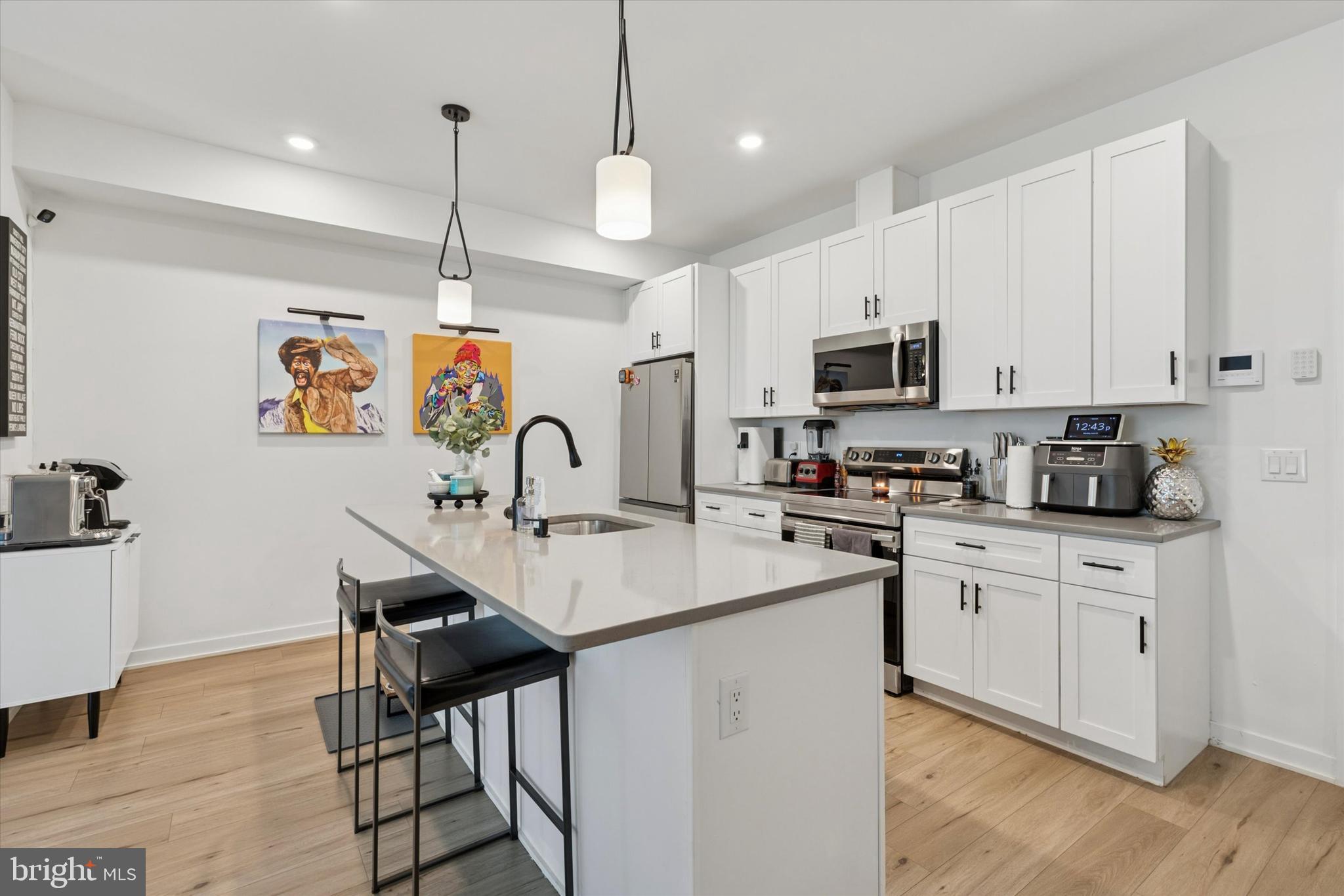 22 East Rittenhouse Street Philadelphia, PA 19144 - Photo 7 of 34 a kitchen with stainless steel appliances granite countertop a stove a sink dishwasher and a refrigerator with wooden floor
