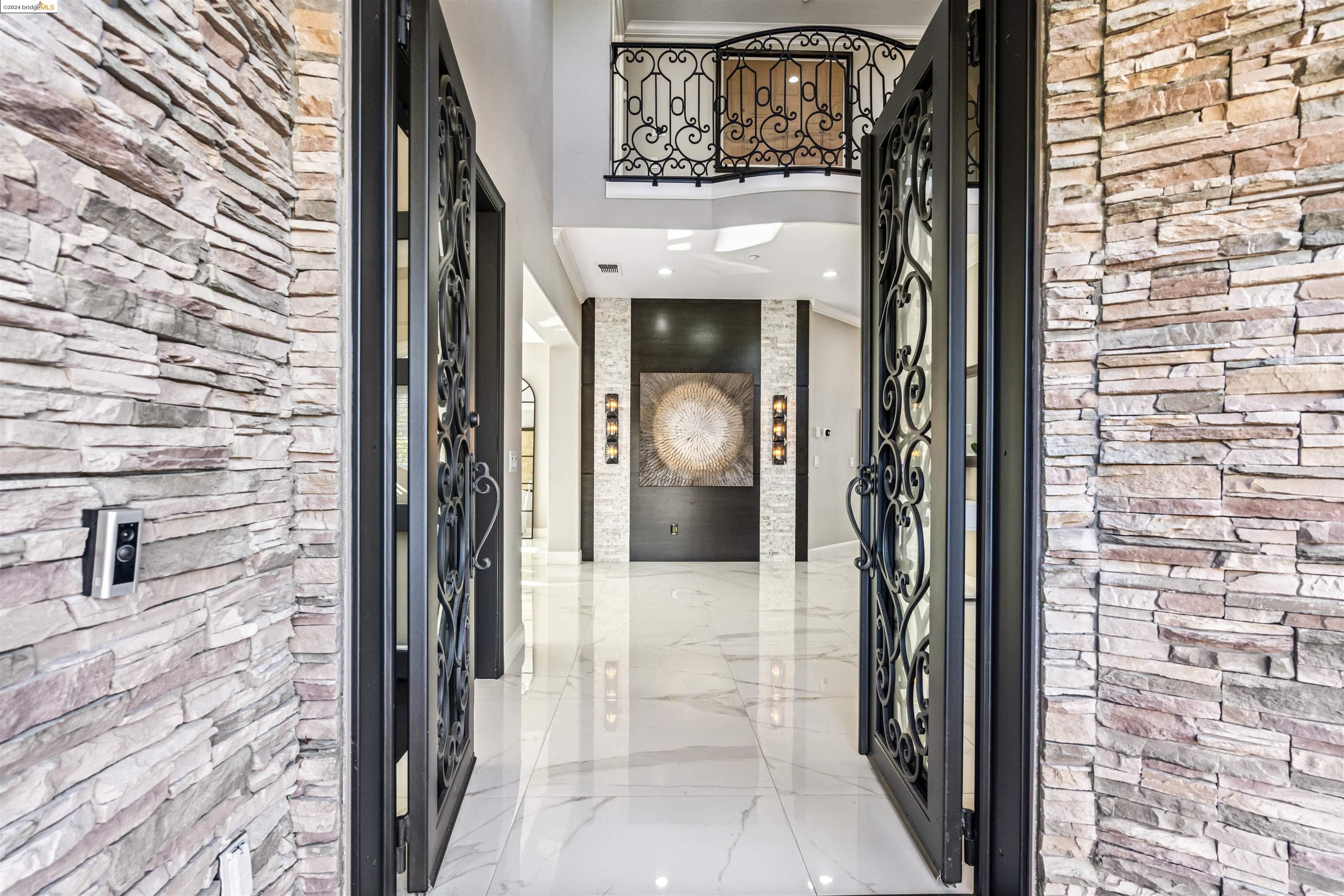 a view of a hallway with a door and wooden floor