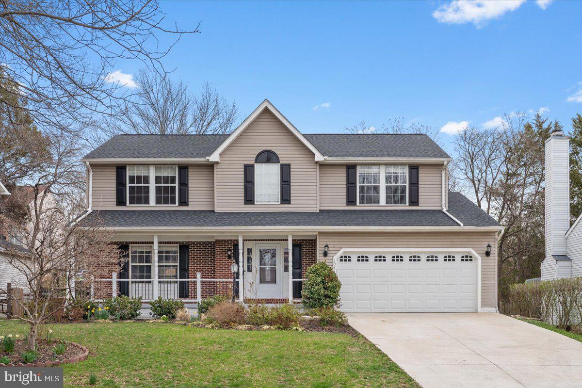 10415 Labrador Loop Manassas, VA 20112 - Photo 2 of 66 a front view of a house with a garden and trees