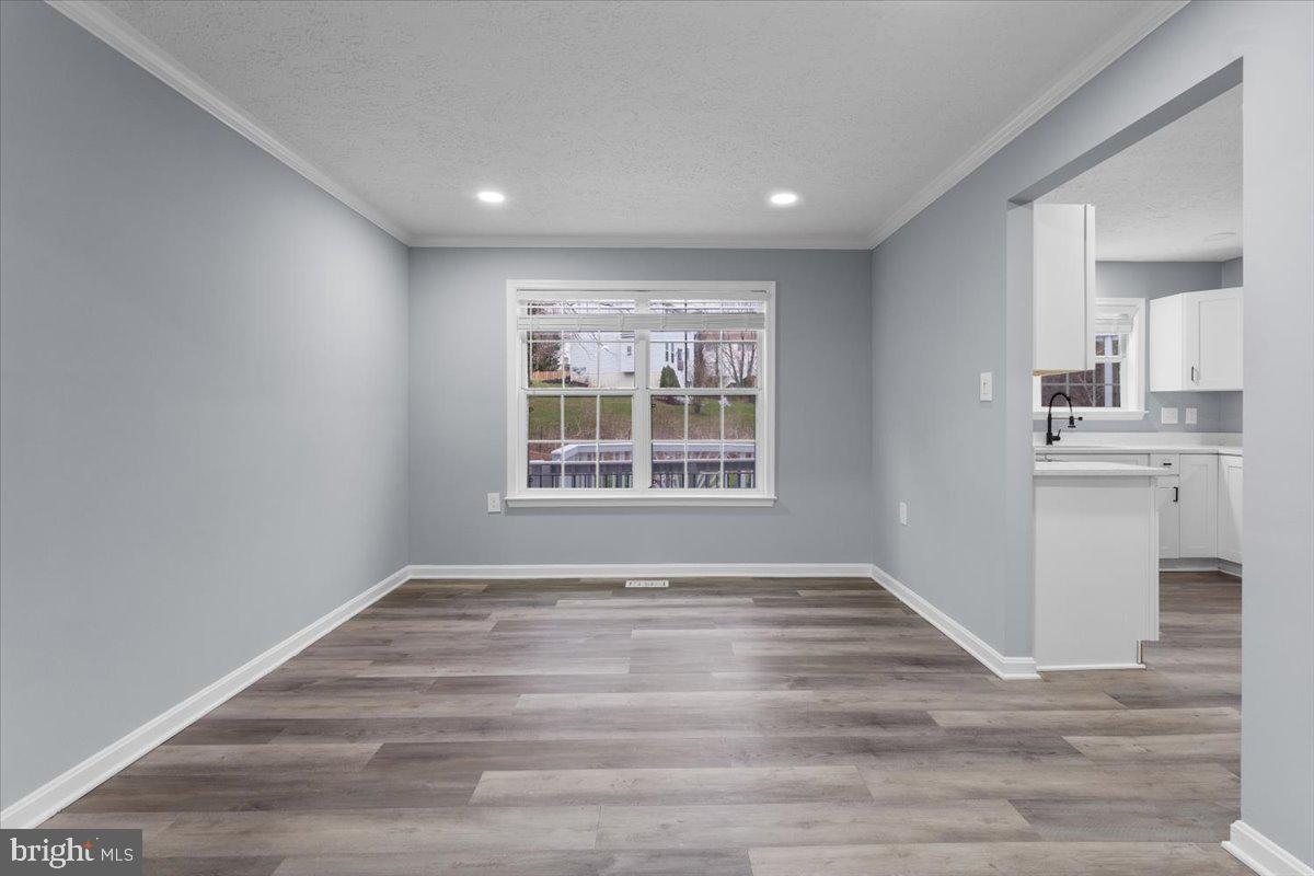10415 Labrador Loop Manassas, VA 20112 - Photo 30 of 66 a view of an empty room with a window and wooden floor