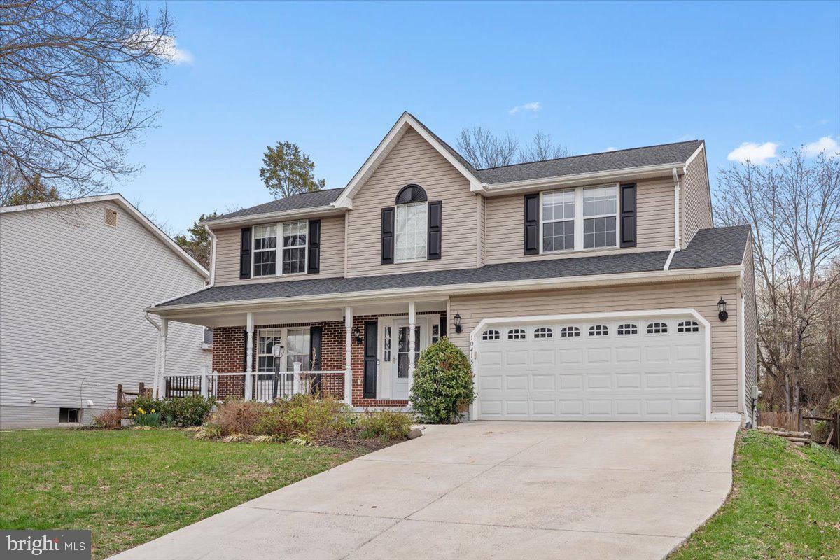 10415 Labrador Loop Manassas, VA 20112 - Photo 3 of 66 a front view of a house with a yard and garage