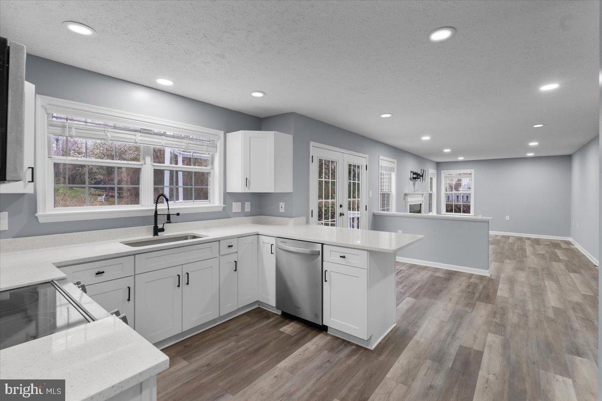 10415 Labrador Loop Manassas, VA 20112 - Photo 32 of 66 a large kitchen with kitchen island a sink stainless steel appliances and cabinets