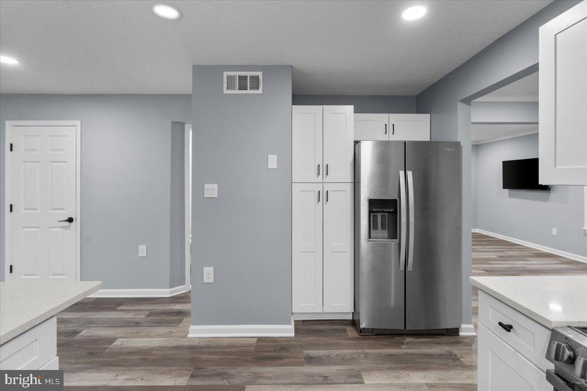 10415 Labrador Loop Manassas, VA 20112 - Photo 34 of 66 a view of a kitchen with a refrigerator and microwave