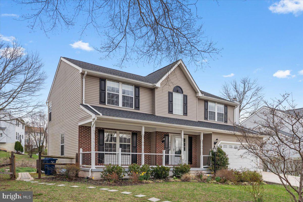 10415 Labrador Loop Manassas, VA 20112 - Photo 4 of 66 a front view of a house with a garden
