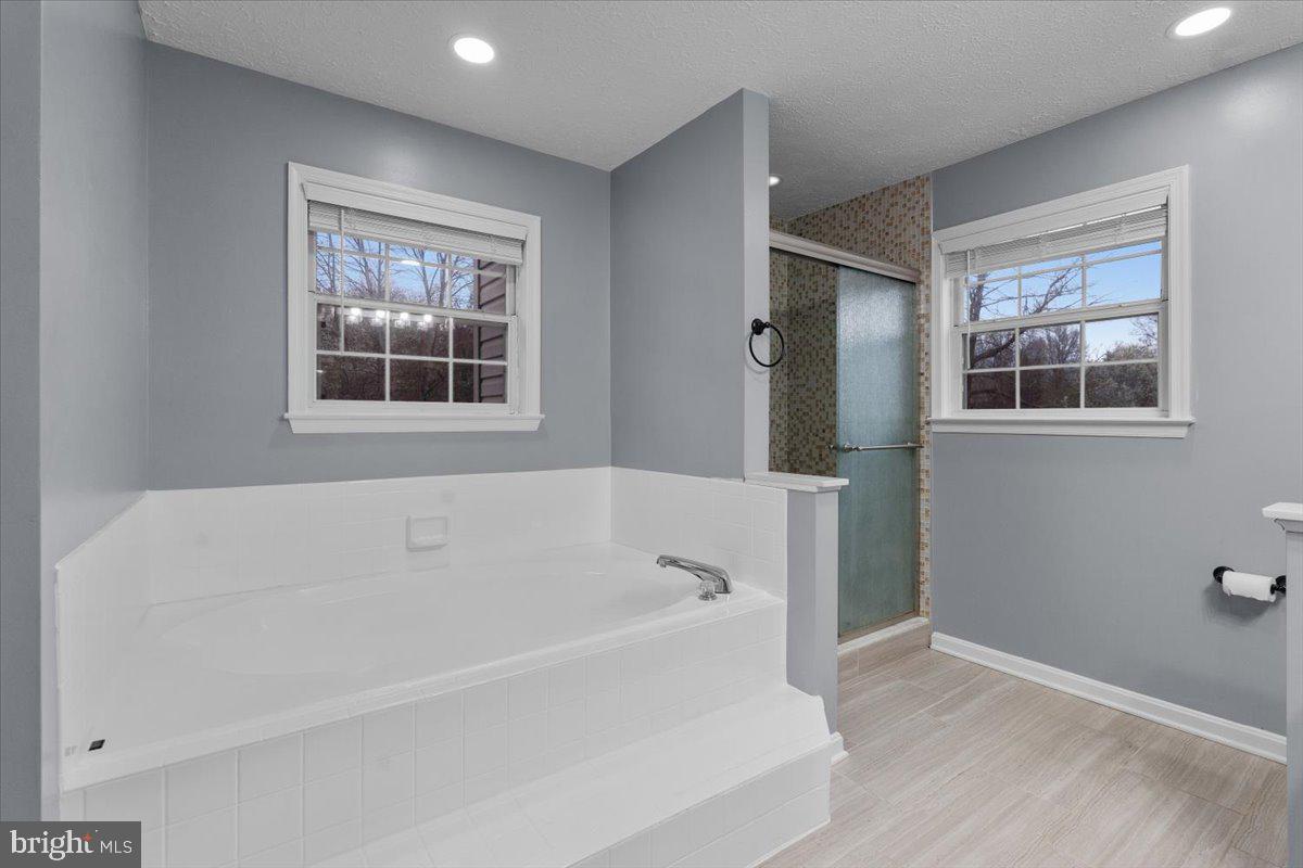 10415 Labrador Loop Manassas, VA 20112 - Photo 45 of 66 a white bath tub sitting next to a window