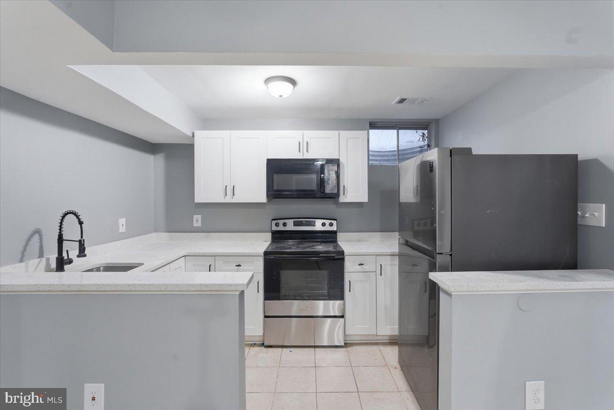 10415 Labrador Loop Manassas, VA 20112 - Photo 54 of 66 a kitchen with a sink and a refrigerator