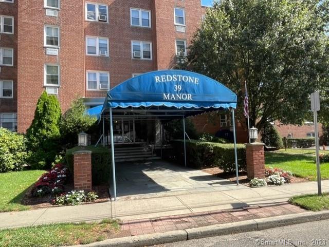 39 Glenbrook Road, Unit 1N Stamford, CT 06902 - Photo 1 of 1 a front view of a house with garden