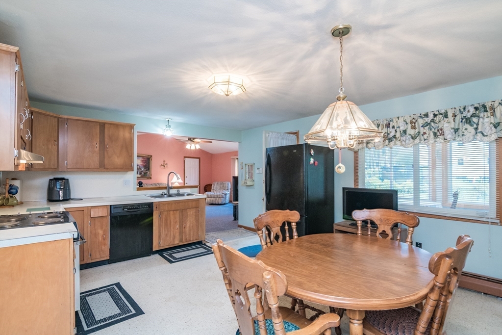 195 Mildred Avenue Springfield, MA 01104 - Photo 12 of 32 a dining room filled chandelier and kitchen view