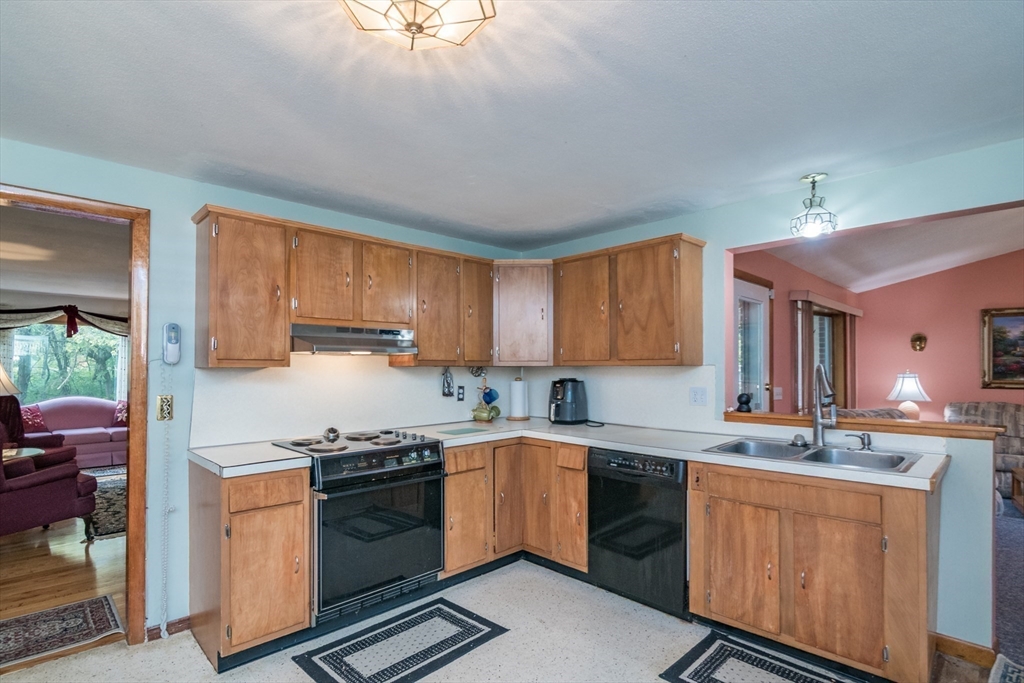 195 Mildred Avenue Springfield, MA 01104 - Photo 13 of 32 a kitchen with stainless steel appliances granite countertop a sink stove and refrigerator