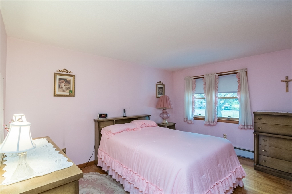 195 Mildred Avenue Springfield, MA 01104 - Photo 17 of 32 a bedroom with a bed and a dresser