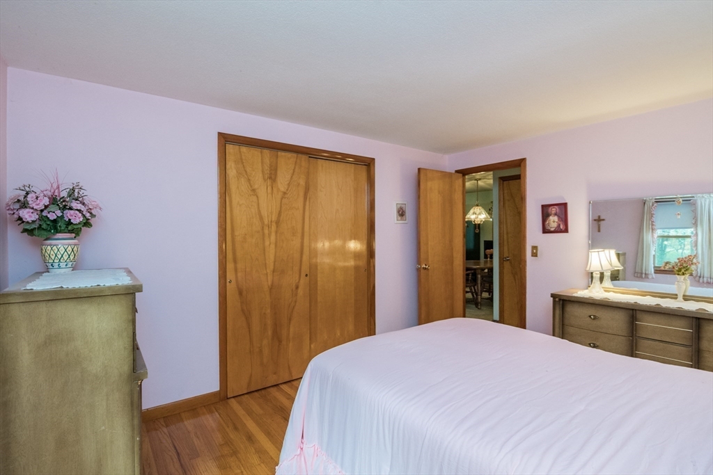 195 Mildred Avenue Springfield, MA 01104 - Photo 18 of 32 a bedroom with a bed dresser and a potted plant
