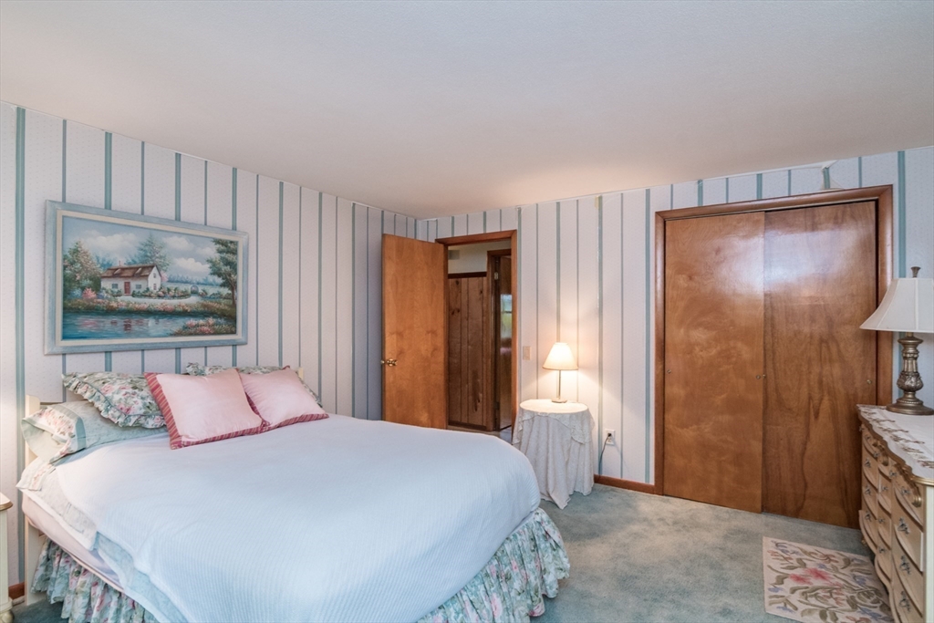 195 Mildred Avenue Springfield, MA 01104 - Photo 19 of 32 a bedroom with a bed and a painting on the wall