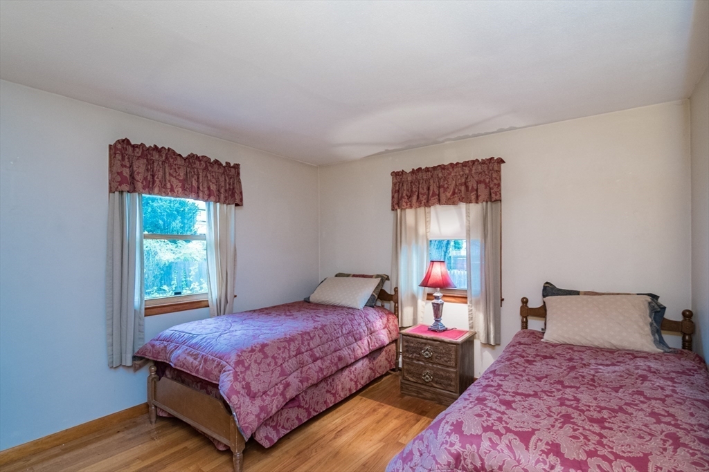 195 Mildred Avenue Springfield, MA 01104 - Photo 21 of 32 a bedroom with a bed and a painting on the wall