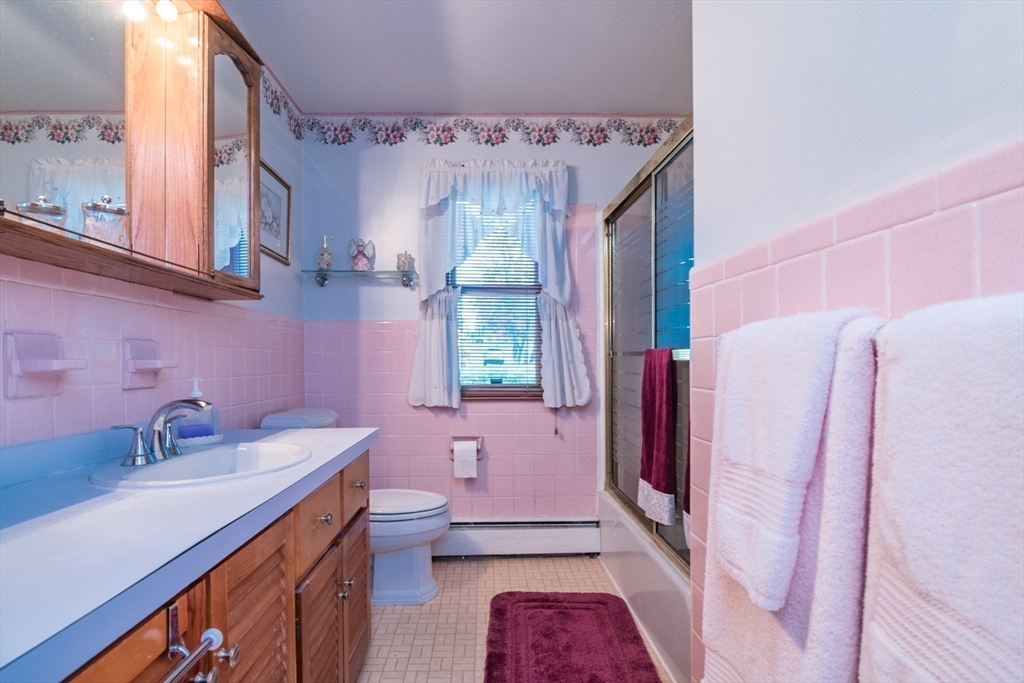 195 Mildred Avenue Springfield, MA 01104 - Photo 22 of 32 a bathroom with a sink a toilet a mirror and shower