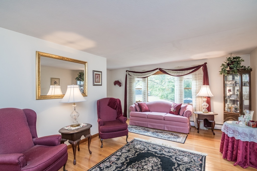 195 Mildred Avenue Springfield, MA 01104 - Photo 9 of 32 a living room with furniture a rug a lamp and a window