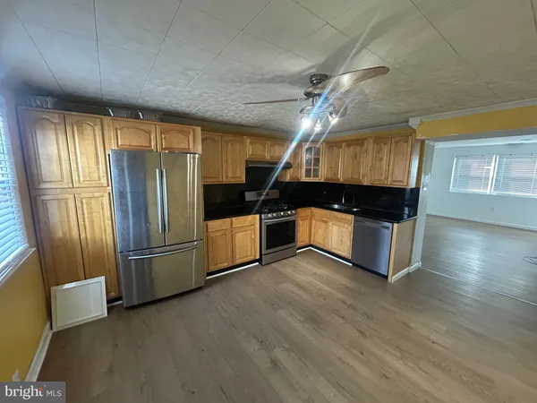 a kitchen with granite countertop a refrigerator and a sink