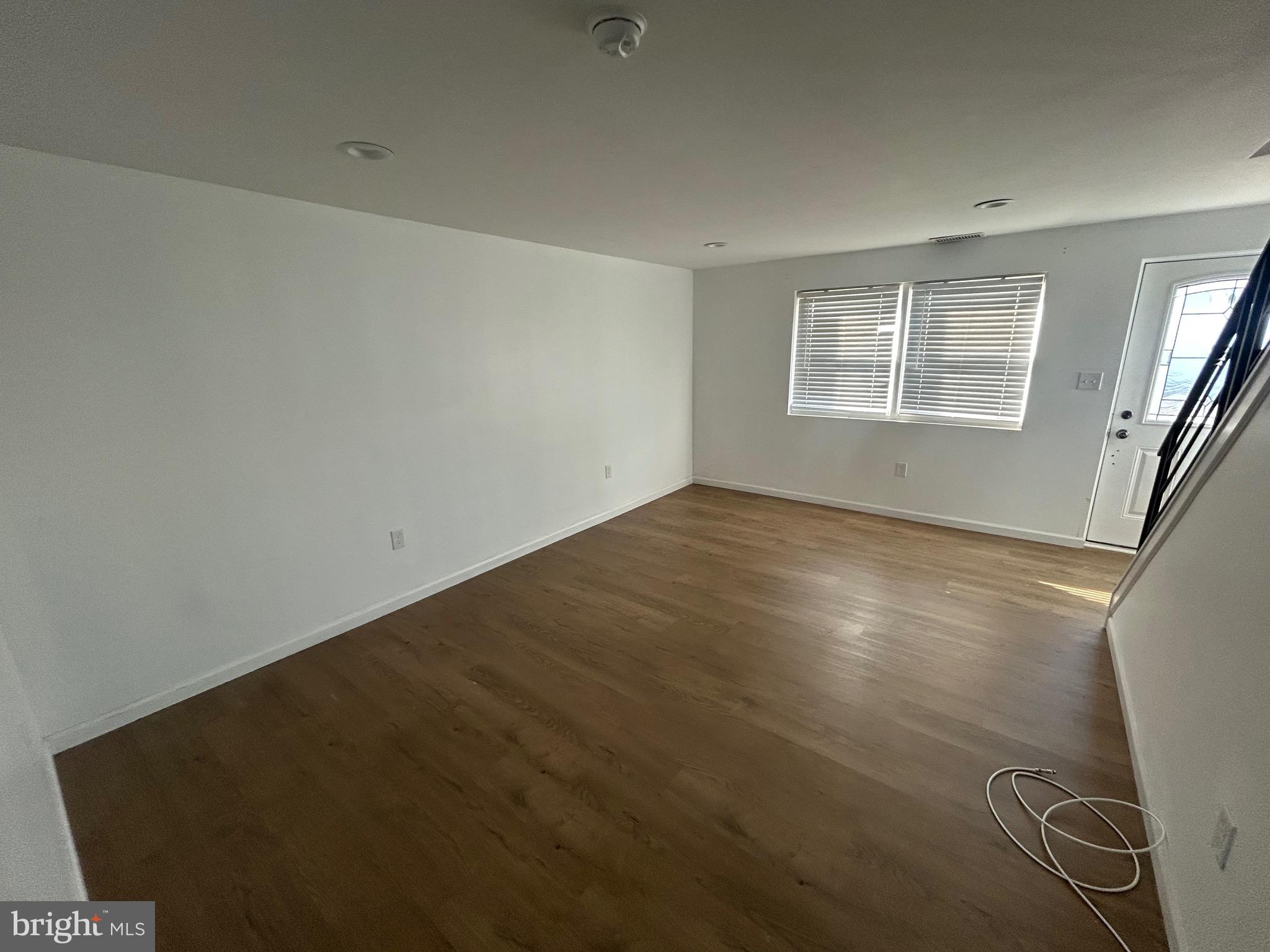 4655 Benson Street Philadelphia, PA 19136 - Photo 13 of 47 an empty room with wooden floor and windows