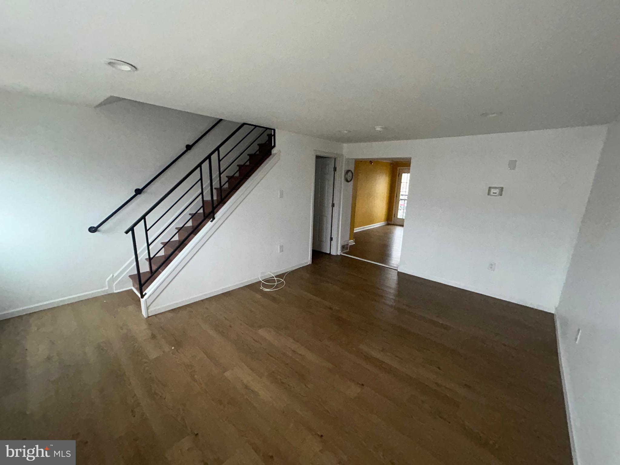 4655 Benson Street Philadelphia, PA 19136 - Photo 16 of 47 a view of an empty room with wooden floor and stairs