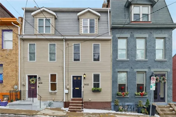 a front view of a residential apartment building with a yard