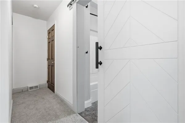 a bathroom with a toilet and shower