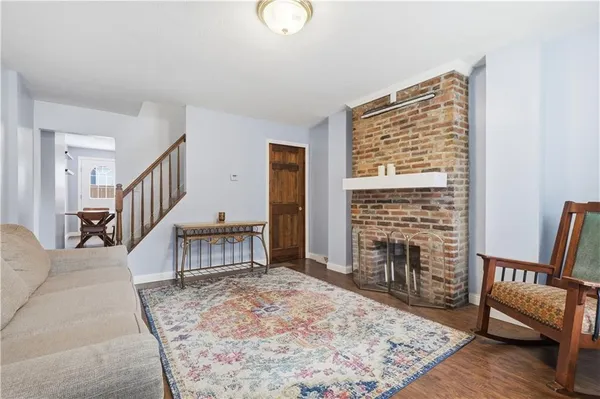 a kitchen with stainless steel appliances a stove a sink refrigerator and a dining table with chair