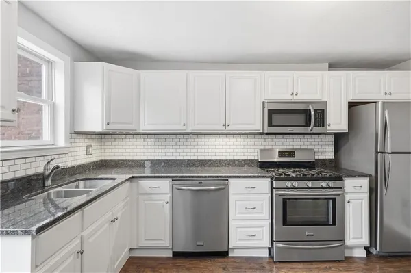 a room with a dresser and a window